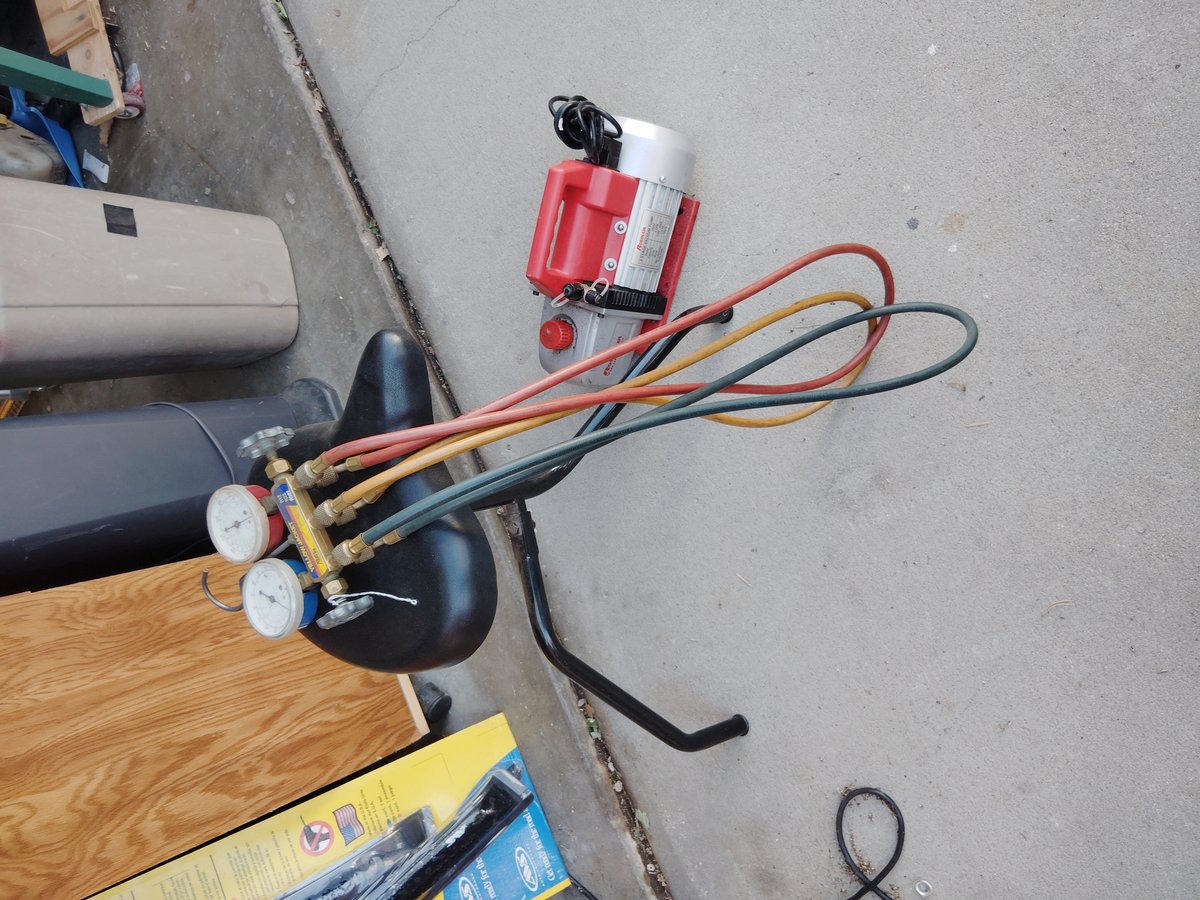 Red and silver machine with colorful hoses attached